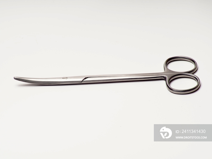 Close up shot of curved stainless steel medical scissor on an isolated white background