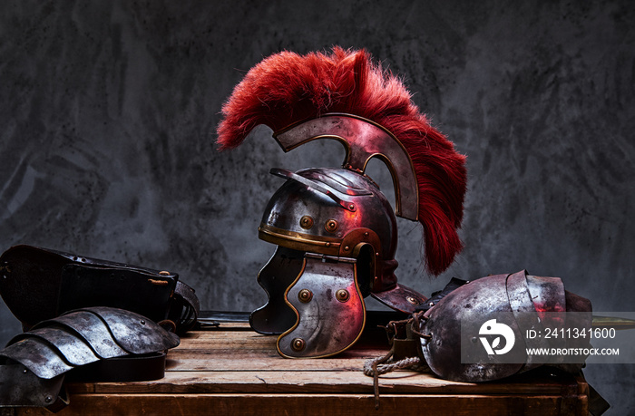 Complete combat equipment of the ancient Greek warrior lie on a box of wooden boards.