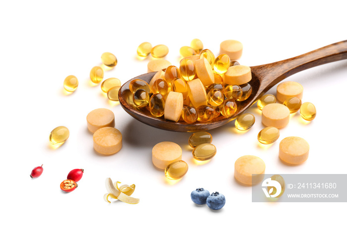 Spoon of different healthy vitamins on white background, closeup