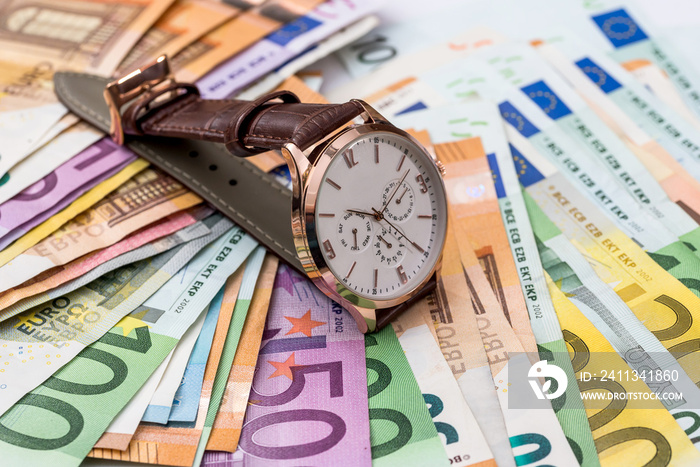 Clock on euro banknotes, time is money