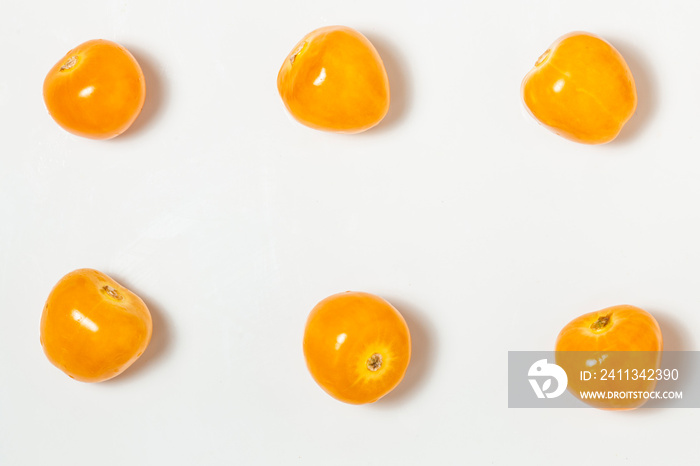 Pattern texture of several Cape Gooseberries, or goldenberries. White background. Top view.