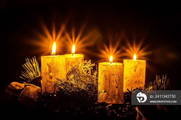 four burning candles on advent wreath