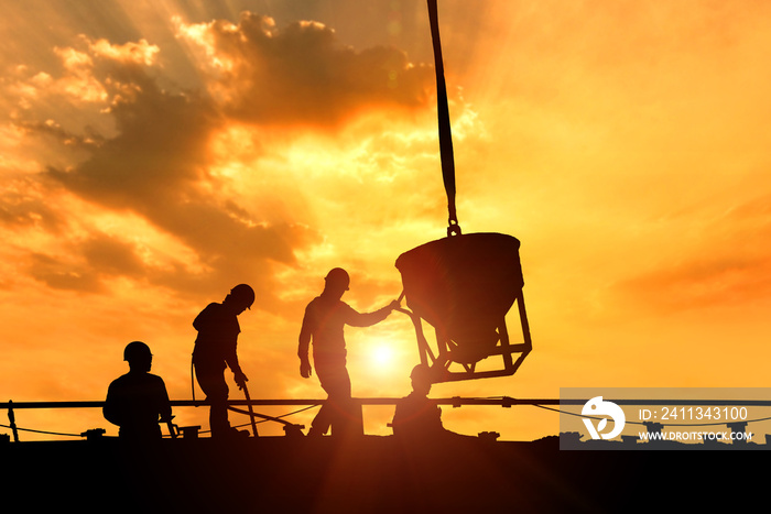 The silhouette of the construction workers at the construction site was cemented.