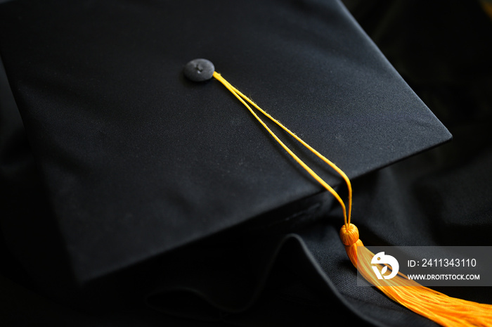 .Close-up Black Graduation Hat and Yellow Tassel placed on the floor