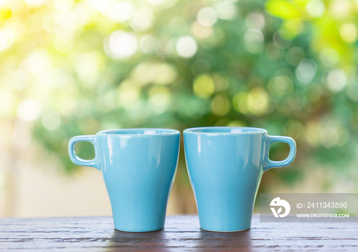 Aqua blue coffee mugs on wooden table symbol happy friendship day.