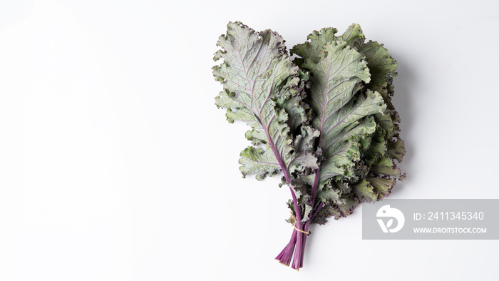 Bunch of fresh red kale over a white background