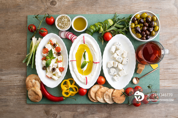 Labneh, Greek cheese with veggies and Cheese with Fennel flower seeds and veggies; Lebanese food of Yougurt and cheese with veggies