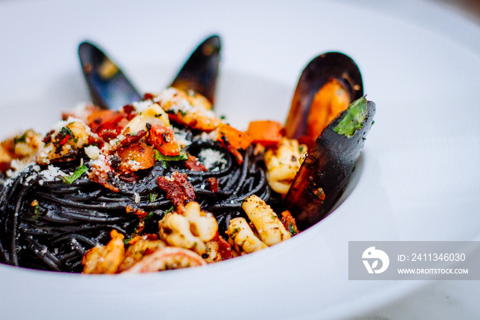 Squid ink pasta with king prawns, herbs and chilli sauce