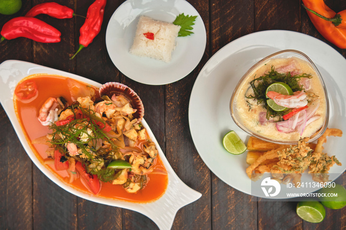 Peruvian food: called  Leche de tigre  and  sudado de mariscos , top view. Selective focus