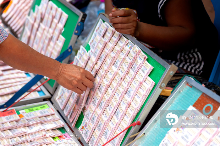 Close up of hand picking  Thai government lottery tickets For fortune