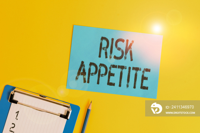 Conceptual hand writing showing Risk Appetite. Concept meaning the level of risk an organization is prepared to accept Clipboard holding paper sheet square page pen colored background