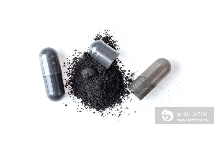 Activated charcoal capsule and powder isolated on white. top view