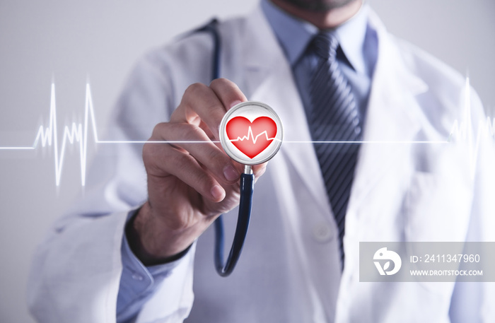 Doctor with stethoscope holding red heart with cardiogram.