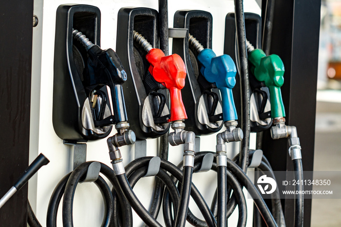 Petrol fuel pumps for filling the car at a gas station in the city.