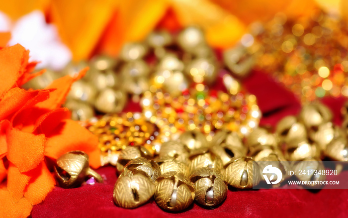 Golden bells of feet anklet tied to the feet of classical Indian dancer with ornaments for Bharatanatyam classical dance in selective focus