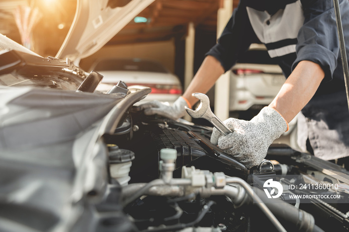 Automobile mechanic repairman hands repairing a car engine automotive workshop with a wrench, car service and maintenance,Repair service.