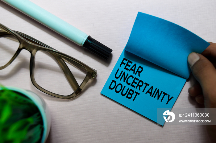 Fear Uncertainty Doubt (FUD) text on sticky notes isolated on office desk