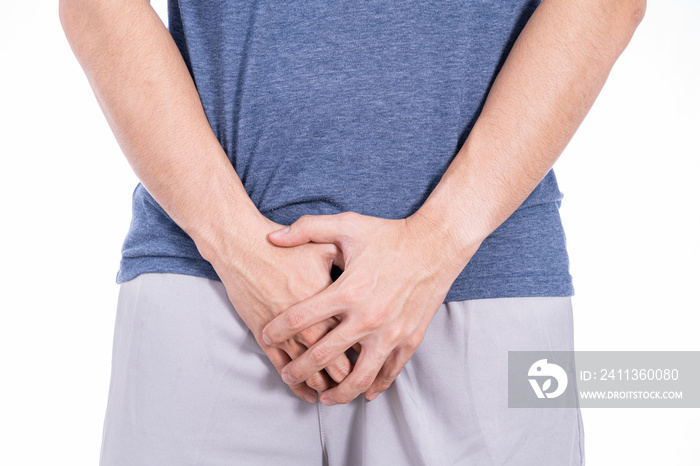 Man hands holding his crotch isolated white background. Medical, healthcare for advertising concept.