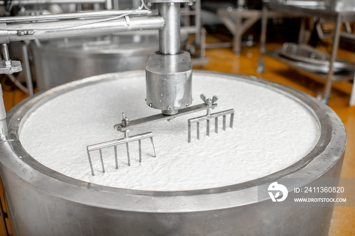 Milk mixing in the stainless tank during the fermentation process at the cheese manufacturing