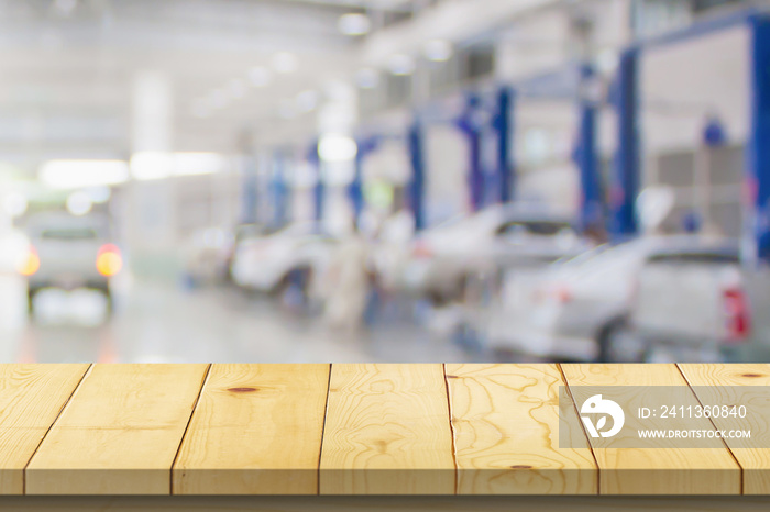 Empty wood table top with car service centre auto repair workshop blurred background