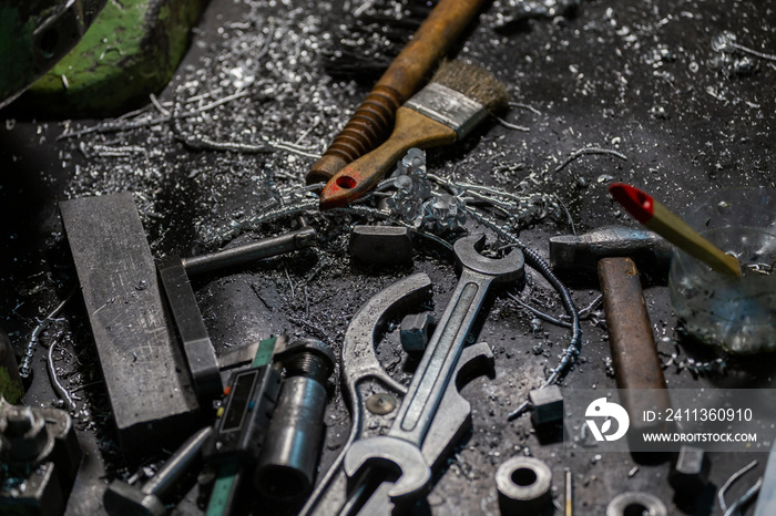 set of tools covered with aluminium metal swarf on machinery worker table