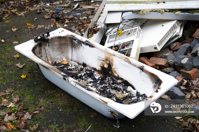 Old ceramic bath from demolition of derelict house on construction building site