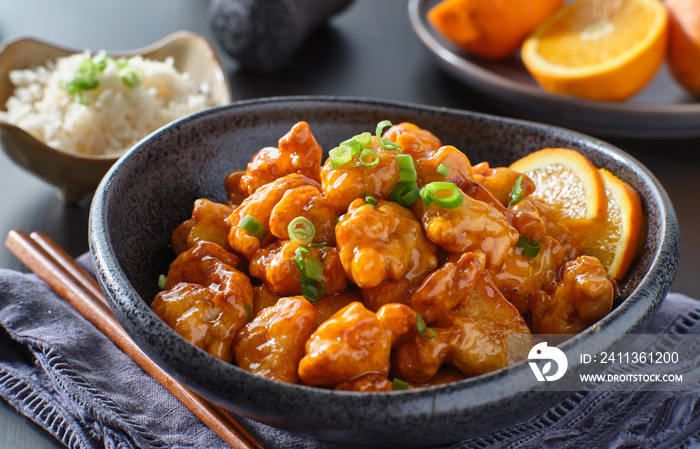 bowl of chinese orange chicken on table top