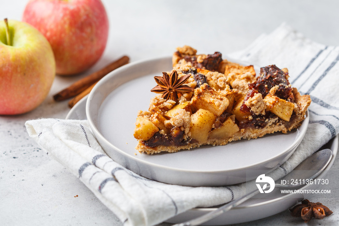 Piece of vegan apple pie with cinnamon, white background. Vegan food concept.