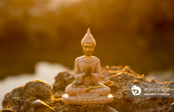 A buddha figure meditating on the coast