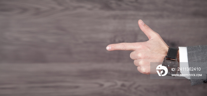 Male hand with finger pointing left direction.