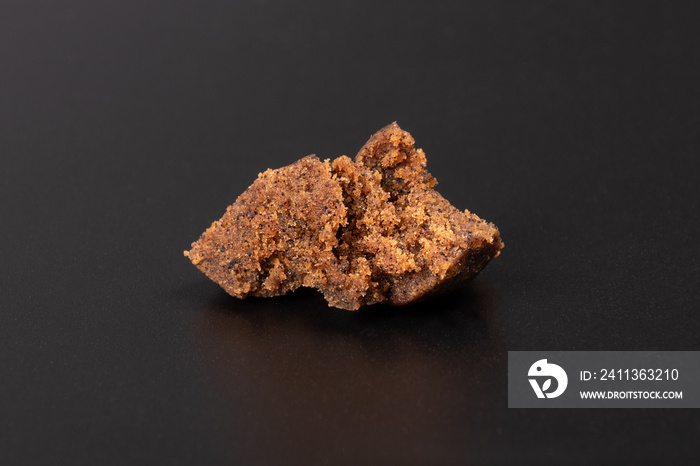 high thc cannabis, concentrate marijuana in the form of hashish amber trichomes on dark background.