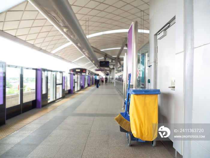 Cleaning tools cart wait for maid or cleaner in the subway (train station). Bucket and set of cleaning equipment in the subway. Concept of service, worker and equipment for cleaner and health