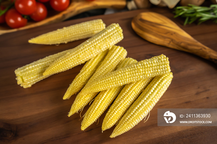 Baby corn on a wooden board