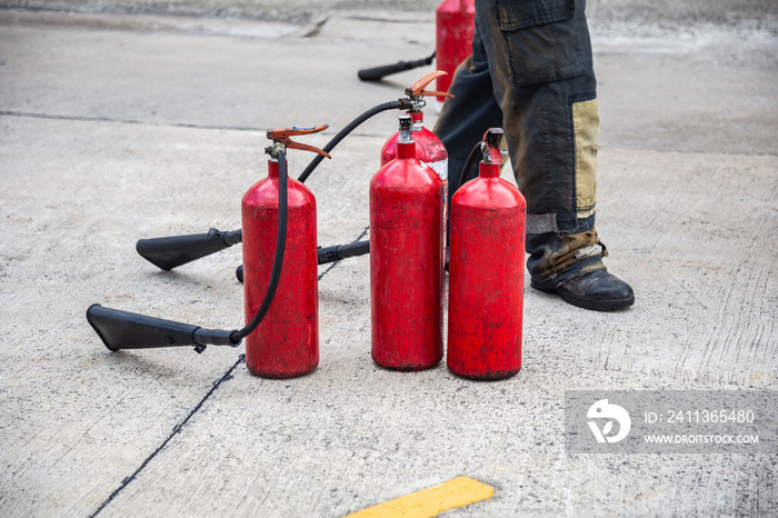 Firemen using extinguisher and water for fight fire during firefight training. All fighter wearing fire suit for safety under danger situation.Fireman work closely with other emergency response agency