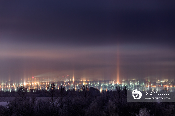 night winter cityscape with light pillars atmospheric phenomenon