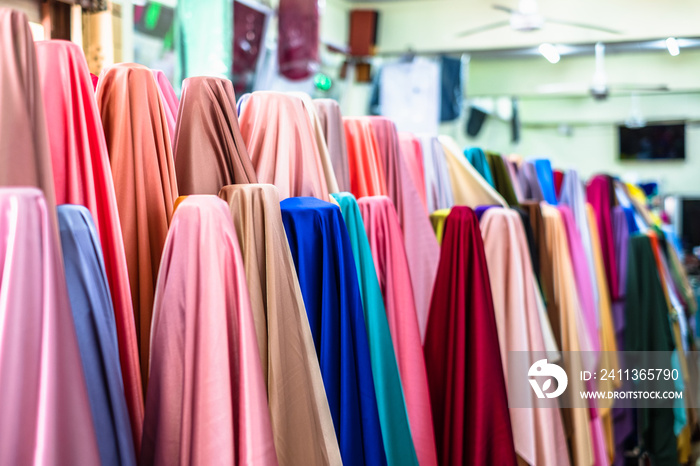 Colorful of many fabric rolls selling in market stall shop. Fashion desig concept.