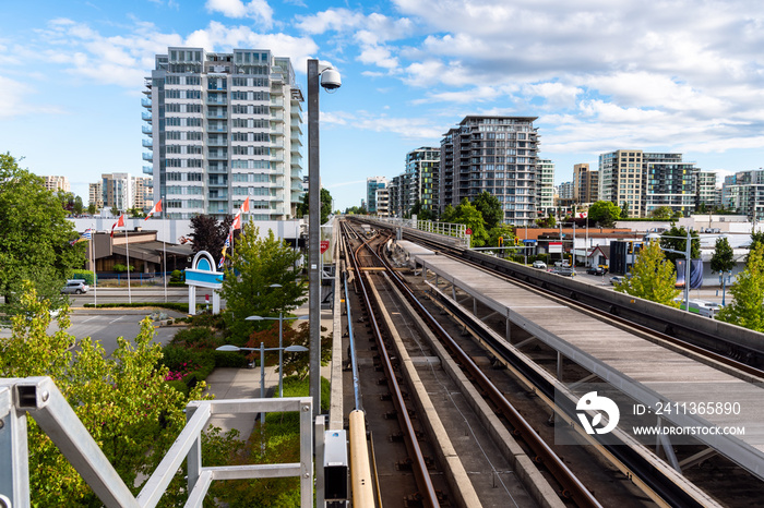 Elevated Rapid Transit System Tacks in a Urban Setting on a Summer Day. Vancouver, BC, Canada.