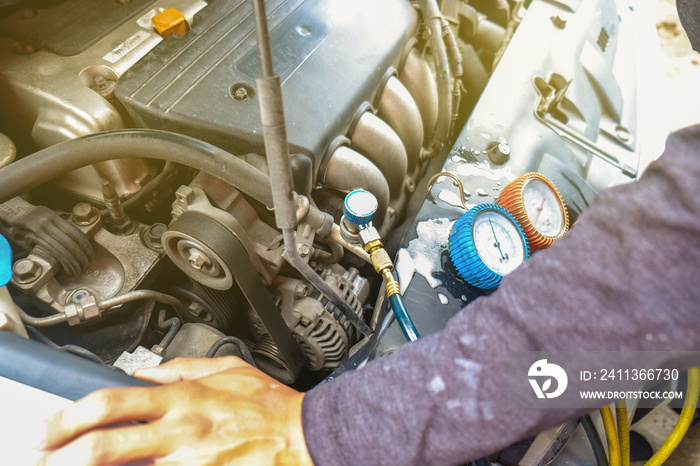 Mechanic check car air conditioner system in garage