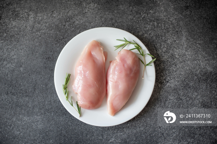 Raw chicken fillet on stone background