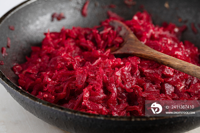 grated beets in frying pan