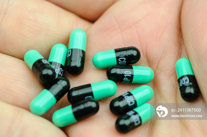 10 Valium tablets (chlordiazepoxide) in the palm of a hand.  This is a high dose (100mg) which would incapacitate most people.