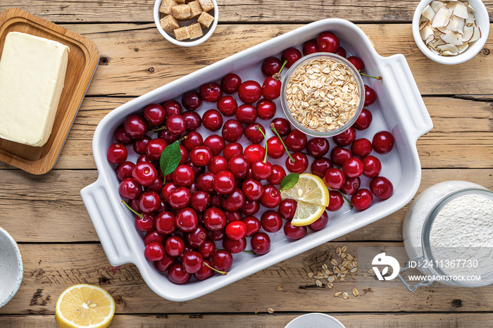 Top view raw ingredients for cooking cherry pie on wooden table