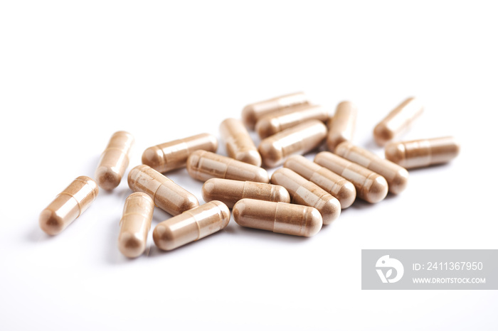 Reishi Mushroom capsules. Concept for a healthy dietary supplementation. White background. Close up.