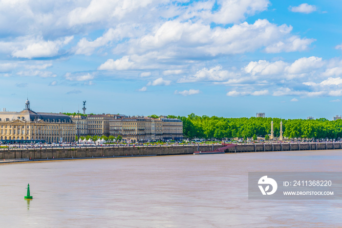 People are enjoying a sunny day on promenade alongisde Garonne river in Bordeaux, France