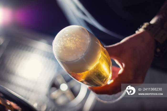 glass of craft beer in bartender hand closeup