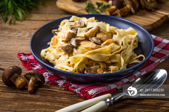 Tagliatelle pasta with forest mushrooms and chicken.