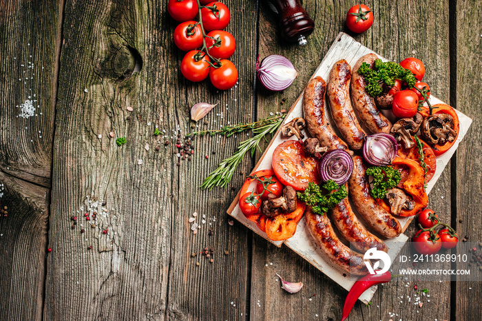 Barbeque menu. Grilled meat assortment of tasty bbq snacks with vegetables on wooden board. banner, menu, recipe place for text, top view