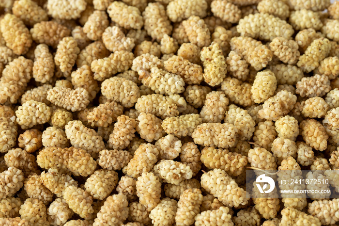 dried mulberry on wooden background close up