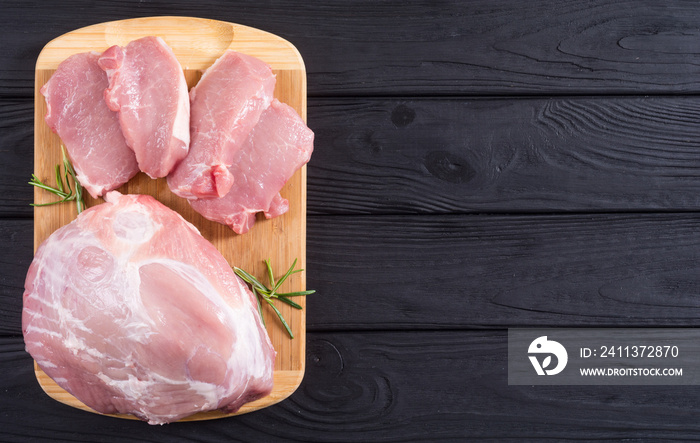 Raw pork meat on wooden background