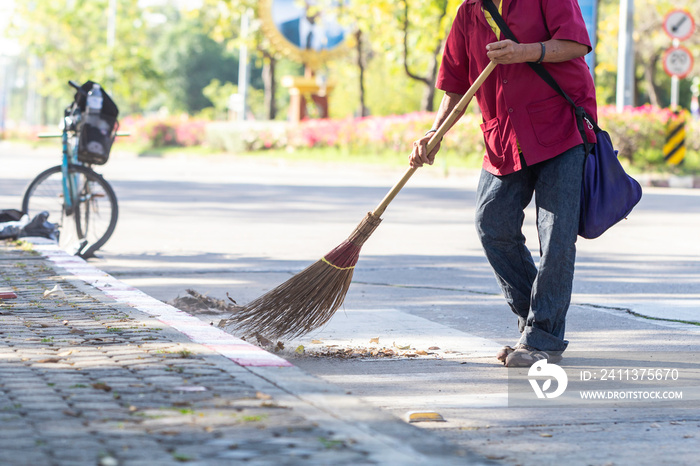 Man cleaning garbage on the road